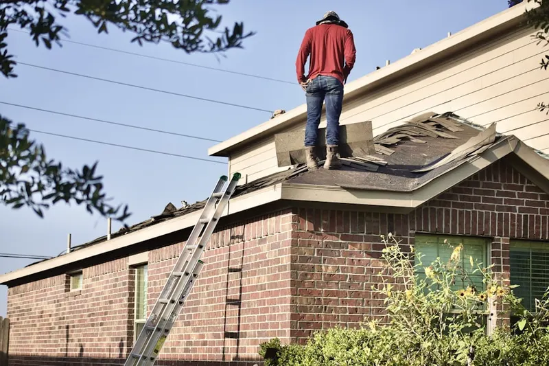 Professional roofer working on a residential roof in Fort Worth Avenue